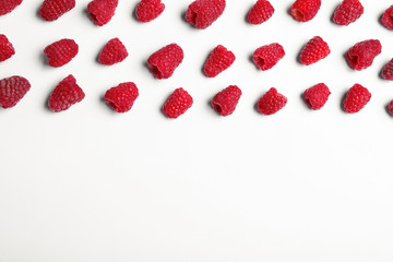 Composition with delicious ripe raspberries on white background, top view
