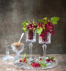 berry dessert with ice cream, gooseberries and red currants and caramel. berry dessert with gooseberries and red currants in a glass.