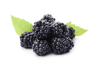 Pile of tasty ripe blackberries with green leaves on white background