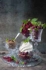 berry dessert with ice cream, gooseberries and red currants and caramel. berry dessert with gooseberries and red currants in a glass.