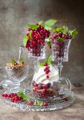 berry dessert with ice cream, gooseberries and red currants and caramel. berry dessert with gooseberries and red currants in a glass.