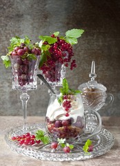 berry dessert with ice cream, gooseberries and red currants and caramel. berry dessert with gooseberries and red currants in a glass.