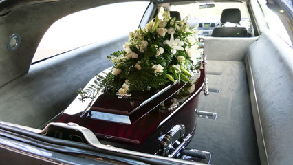 closeup shot of a funeral casket in a hearse or chapel or burial at cemetery - obrazy, fototapety, plakaty