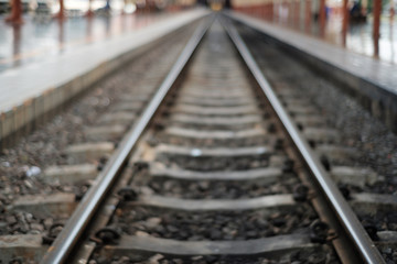 Fototapeta premium Blurred of railway tracks at train station,abstract for background