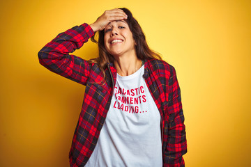 Beautiful woman wearing funny t-shirt with irony comments over isolated yellow background stressed with hand on head, shocked with shame and surprise face, angry and frustrated. Fear and upset