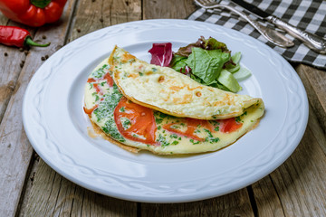 omelette breakfast on plate on wooden table