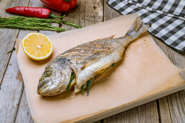 Dorado on grill on wooden table