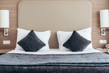 bed with pillows and cushions in cozy hotel room