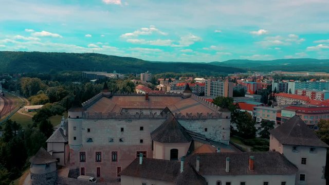 Aerial view of castle in slovak town Zvolen surrounded by mountains.