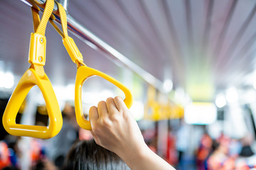 Safety handgrip in the public transportation ship full with passengers in the ship.