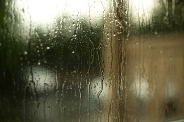 Drops of rain on the glass of window