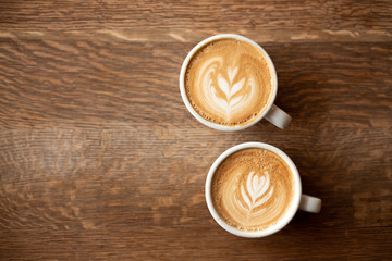 Fototapeta na wymiar Two cups of coffee on a dark wooden background