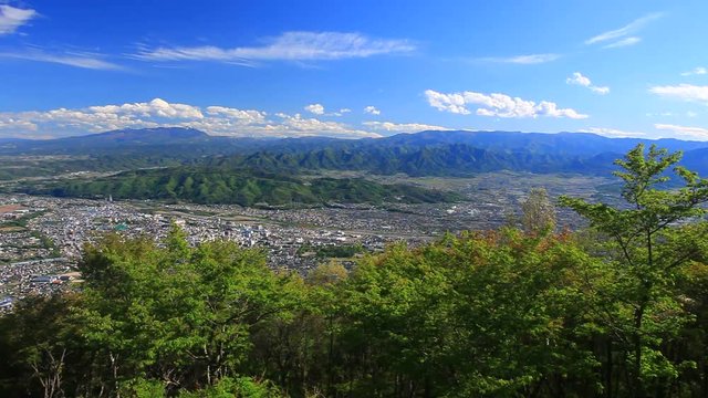 Panning shot of Ueda City in mountain landscape, Japan