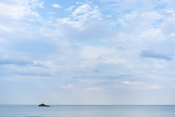 Landscape of sea and cloudy sky with small island.