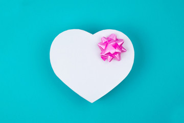 White heart shaped gift box with pink bow for holiday, christmas, thanks giving day, birthday top...