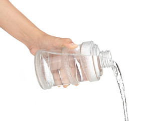 Pouring water from bottle isolated on white background