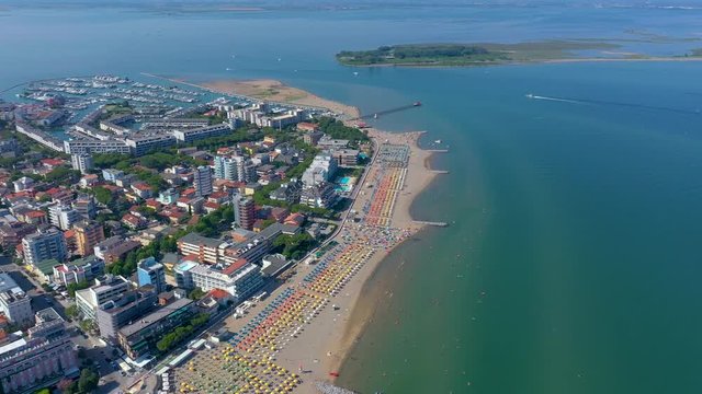 LIGNANO, ITALY - MAY, 2019: Lignano beach at Adriatic sea coastline in Italy aerial drone view. Europe during summer.
