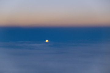 Bright moon sinking into the clouds with copy space