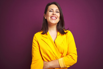 Young beautiful brunette woman wearing elegant yellow jacket over purple isolated background with a happy and cool smile on face. Lucky person.