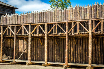 Medieval wooden fence made of palisade