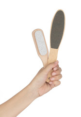 Hand holding stone scrub foot hygiene tool isolated on white background