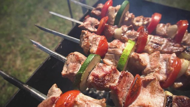 bright vegetable meat skewers on skewers cooked on a brazier in a park smoked on charcoal close-up