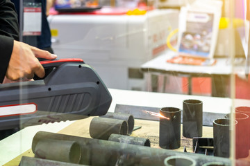 close up work piece (steel pipe) during rust or dirt remove by high technology laser beam cleaning machine