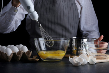 mixer and dough. recipe of pie or cake or cheesecake concept on dark