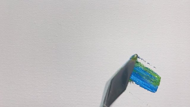 Blue green color brush stroke on white canvas close-up