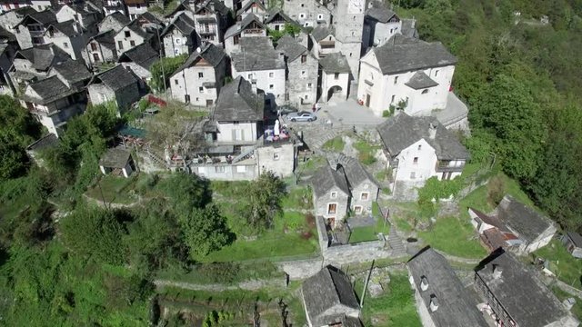 revealing aerial shot of medieval town village of Corippo in the mountains, small mountain village in Ticino Corippo, Verzasca valley, Switzerland