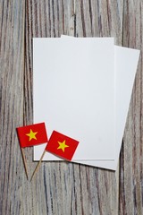 September 2, July 27, happy independence day Vietnam. memorial day for independence. the concept of patriotism. mini flags on wooden background with white paper sheets. vertical