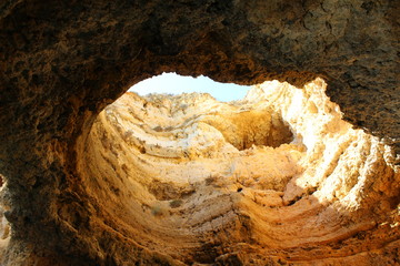 Cave, blue sky desert sand