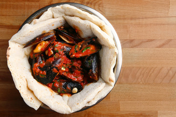 pizza with mussels on table restaurant traditional pizza with basil leaf
