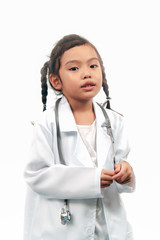 portrait of asian child girl playing roleplay being a doctor in lab coat with stethoscope