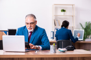Young and old employees working together in the office