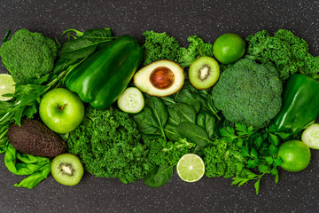 Selection of healthy green food fresh vegetables and fruit. Concept of green color, clean eating, vegetarian and vegan food and cuisine, lifestyle, diet, and fitness