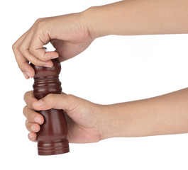 Hand holding Pepper mill isolated on white background
