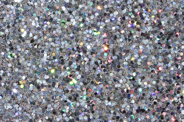 Defocused macro abstract background of sparkling silver glitter texture