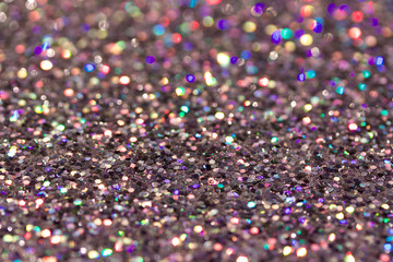 Defocused macro abstract background of sparkling silver glitter texture