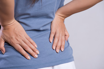 Close up woman having pain in injured back. Healthcare and back pain concept.