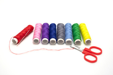 Color sewing threads isolated on white background.