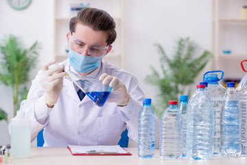 Young male chemist experimenting in lab
