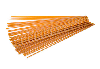 Whole wheat spaghetti on white background.