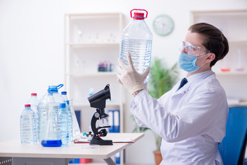 Young male chemist experimenting in lab