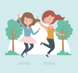 happy young women celebrating jumping in the forest landscape