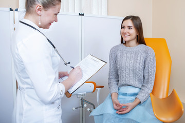 Young woman patient with gynecologist.