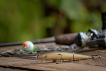 Obraz premium Fishing lure rod and reel in background 