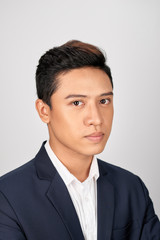 Portrait of serious businessman in suite on white background