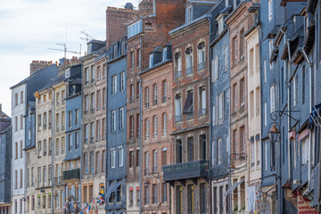 Fototapeta na wymiar Honfleur, France - 06 01 2019: View of the facades of houses at sunset