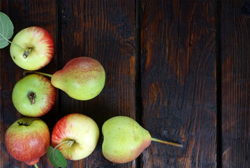 apples and pears on a dark background